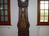 a grandfather clock in the corner of a room