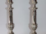 pair of silver candlesticks on a white background