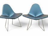 pair of blue chairs with metal legs on a white surface