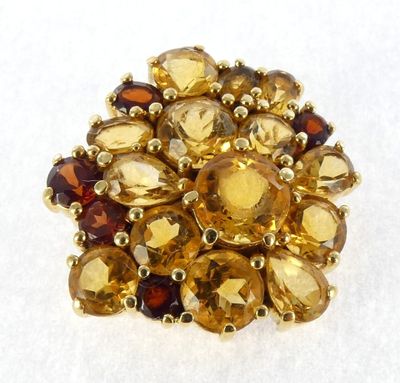 a close up of a yellow and brown ring on a white surface