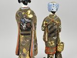 two asian figurines of a woman and a man in kimono robes