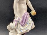 a figurine of a woman and a child on a rock