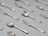 a lot of silver spoons and forks on the table