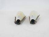 a pair of white and black earrings sitting on top of a white surface