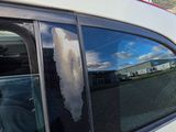 a dog sitting in the passenger seat of a car