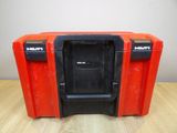 a close up of a red and black tool box on a wooden table