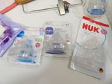 many items that are on a table that include a baby bottle, a stethoscope, and other items