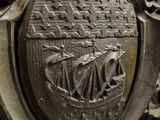 a close up of a metal plate with a coat of arms on it