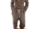 bronze figurine of a man in a top hat and coat