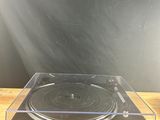 a close up of a record player sitting on top of a wooden table