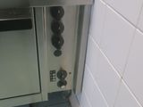 a silver oven that is in the corner of a kitchen