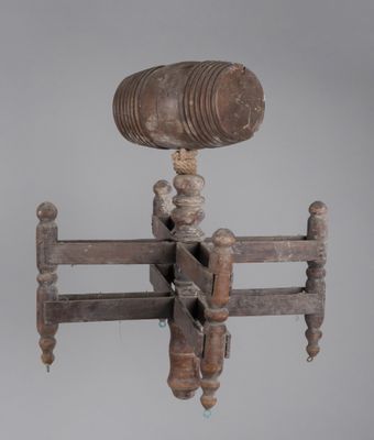 a large wooden object with a metal object on it