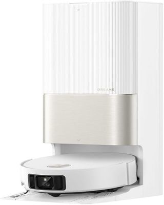 a close up of a white speaker with a remote on top of it