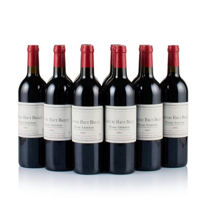 six bottles of red wine are lined up in a row