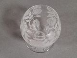 a glass cup with a design on it on a table