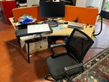 a desk with two monitors and a laptop on it