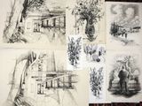 sketches of a house and a tree on a table in a drawing class