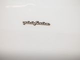 a close up of a white plate with a logo on it