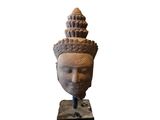 a close up of a statue of a head on a stand