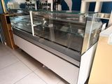 a glass display case in the middle of a store