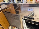 a dog that is sitting inside of an oven