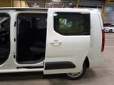 a white van with its doors open in a garage