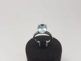 an image of a ring with a blue topaz stone on it