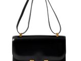 un sac à main noir avec des finitions dorées sur la poignée