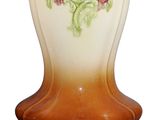 a vase that has flowers painted on the side of it