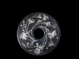 a black and white circular object with flowers on it