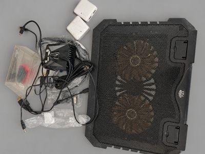 a black cooler sitting on top of a table next to a charger