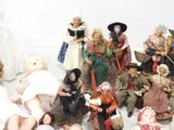 a lot of dolls that are sitting on the floor