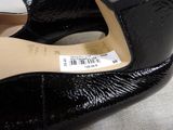 a close up of a pair of black shoes with a price tag on it