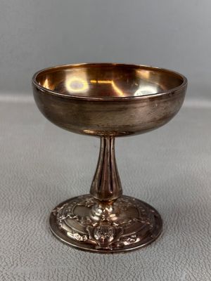 an image of a silver bowl sitting on top of a table