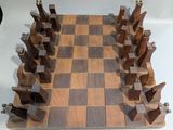 a wooden chess board with pieces of wood on it