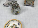 a table with a lot of vases and plates on it