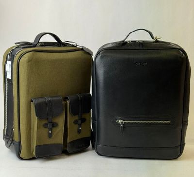 two pieces of luggage sitting next to each other on a table