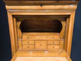 a wooden cabinet that has a clock on top of it