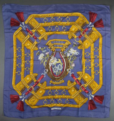 a blue and yellow scarf with a picture of a horse on it
