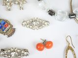 many different types of jewelry on a white surface