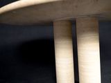 a small table with two wooden legs on a black background