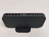 a close up of a black device on a white surface