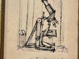 an old drawing of a microscope on display in a gold frame