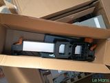 a cardboard box with a stapler and a stapler in it