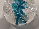 a glass ball with water inside of it on a table