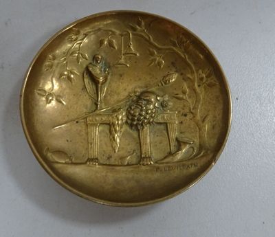 an image of a gold plate with a lion and a bird on it