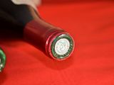 two bottles of wine sitting on a red cloth