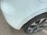 a close up of a car ' s front bumper with a dent on it