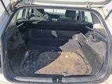 the back of a car with its trunk open and the seat folded down