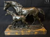 statue of a horse and foal with a foal on a marble base